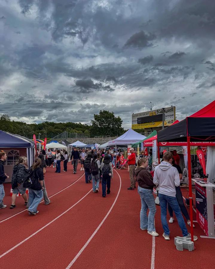 A view across the exhibition grounds at the Vogtlandstadion in Plauen, with pavilions lining the running track